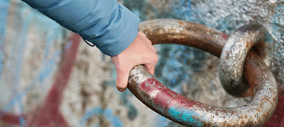 Veränderung im Team, Teamentwicklung Methoden, Hand zeiht an schwerem Metallring